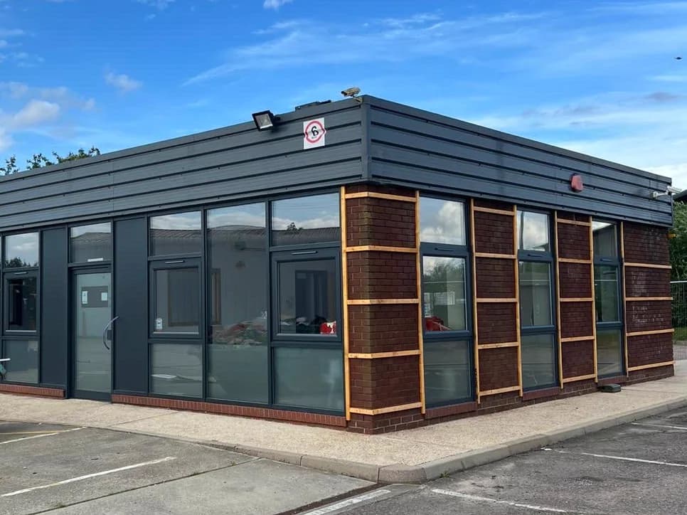 Commercial unit in Suffolk with external cladding and window frames sprayed grey by UK Spray Factory